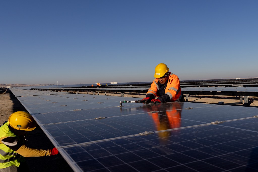 Workers setting up solar panels